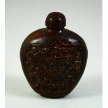 A SMALL CHINESE SNUFF BOTTLE AND STOPPER, possibly horn, with panels of a sage and deer, 7cm high.