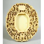 A CHINESE CANTON CARVED IVORY FRAME, finely carved with scenes of figures in various pursuits, 11.