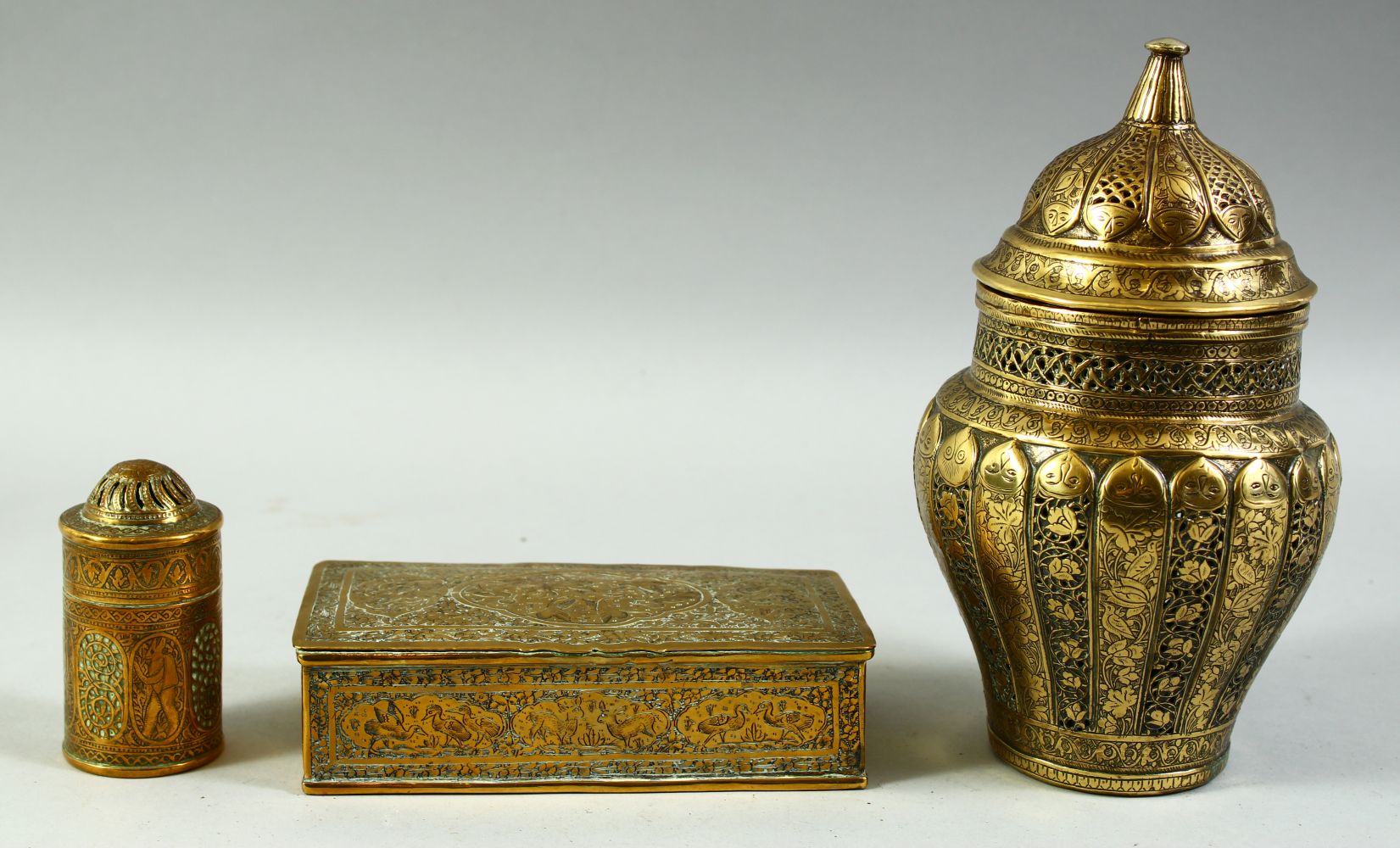 THREE 19TH CENTURY PERSIAN QAJAR BRASS ITEMS, including a rectangular lidded box, an openwork jar