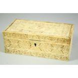 A FINE 18TH CENTURY INDIAN OR SRI LANKAN IVORY BOX, the hinged lid carved with a figure and