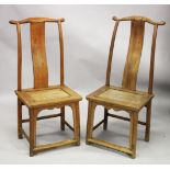 A PAIR OF CHINESE ELM YOKE BACK CHAIRS, possibly 18th century or earlier, with plain curving back