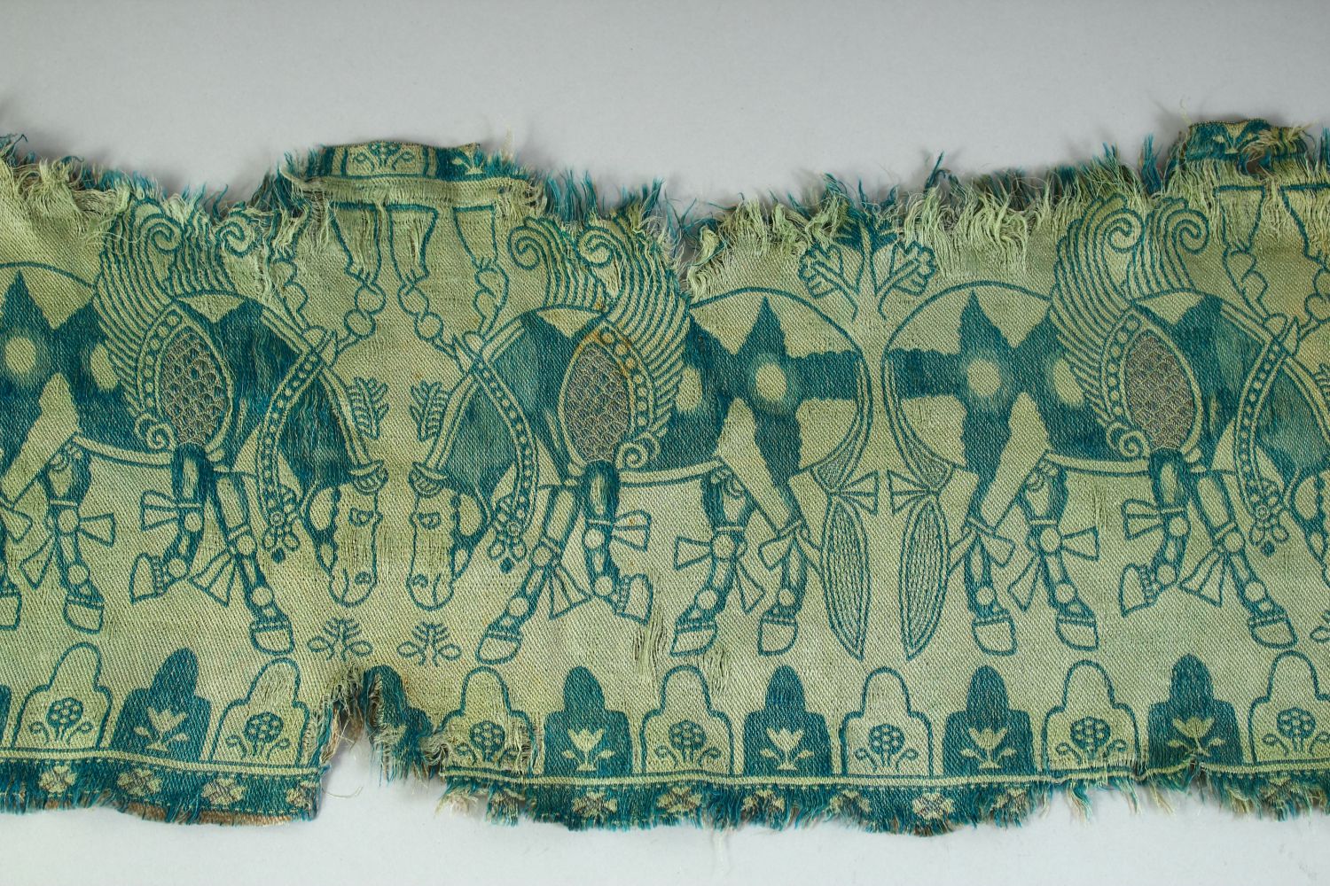 AN ISLAMIC TEXTILE FRAGMENT, embroidered with horses. - Image 3 of 8