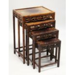 A GOOD NEST OF FOUR CHINESE HARDWOOD RECTANGULAR TABLES, with faux bamboo carved frames, fruiting
