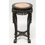 A CHINESE CARVED HARDWOOD AND MARBLE INSET VASE STAND, with pierced and carved frieze depicting