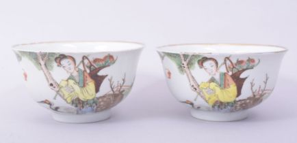 A PAIR OF 20TH CENTURY PORCELAIN BOWLS, each decorated with a female figure with a crane and a
