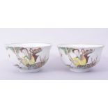 A PAIR OF 20TH CENTURY PORCELAIN BOWLS, each decorated with a female figure with a crane and a