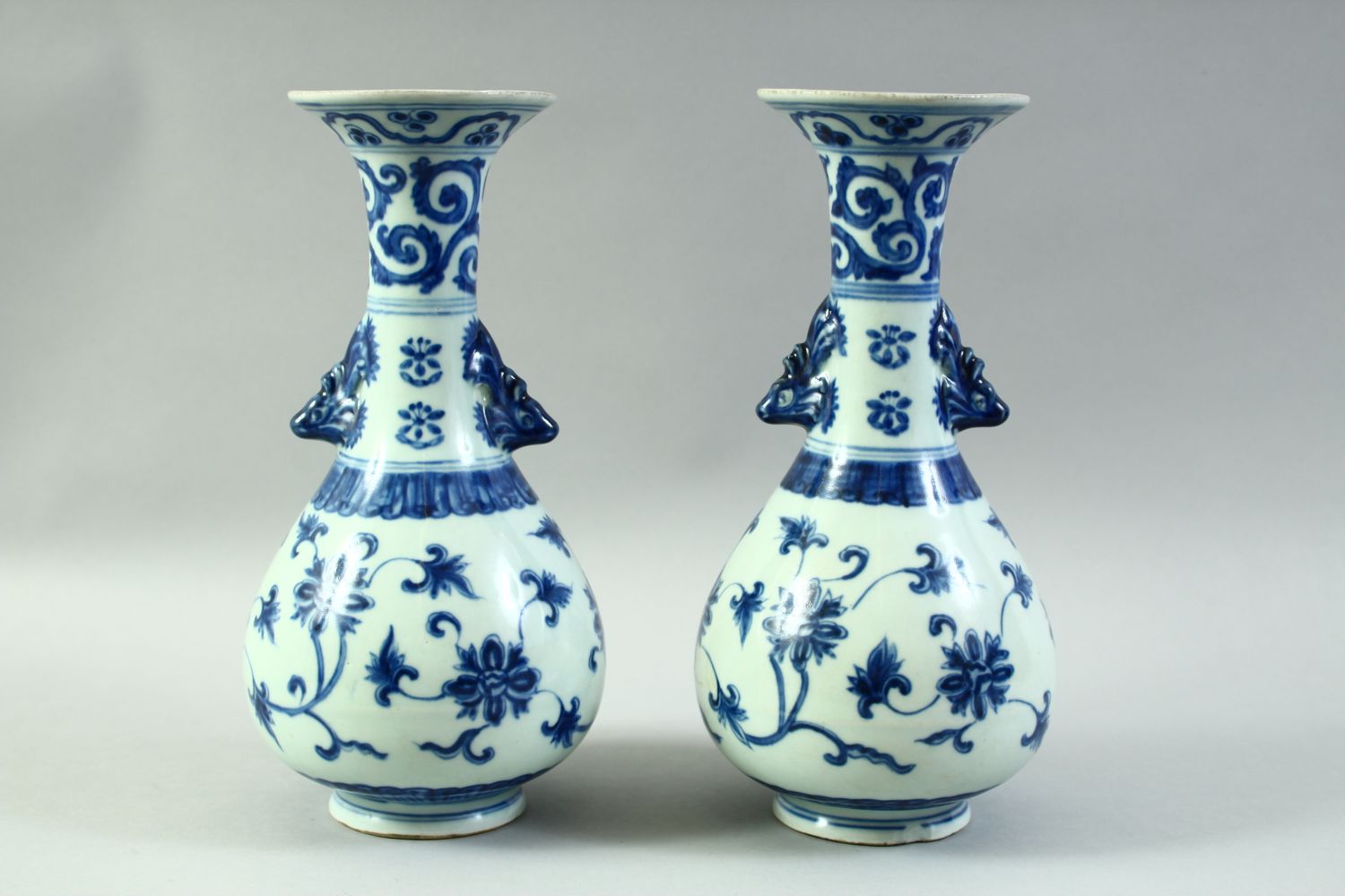 A PAIR OF CHINESE BLUE AND WHITE PORCELAIN VASES, with formed handles and floral decoration, 27. - Image 3 of 6