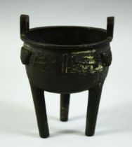 A CHINESE MING STYLE BRONZE TRIPOD CENSER, possibly early, 13cm high.