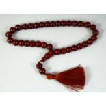 AN ISLAMIC SET OF CHERRY AMBER PRAYER BEADS, each beads approx.12mm.