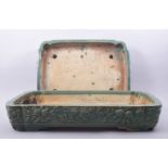 TWO LARGE CHINESE GREEN GLAZED RECTANGULAR PLANTERS, with raised floral decoration, 51cm x 38cm