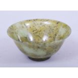 A SMALL CHINESE SPECKLED JADE BOWL, 10cm diameter.