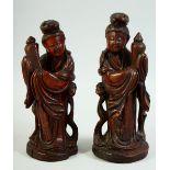 A PAIR OF CHINESE CARVED WOOD FEMALE FIGURES, 22cm and 21cm.