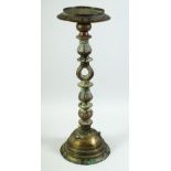 AN ISLAMIC ENGRAVED BRASS LAMP STAND, engraved with calligraphy and various motifs, 55.5cm high.