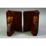 A PAIR OF DUNHILL HENRY HOWELL STYLE BIRD FORM BOOK STANDS WITH BAKELITE BEAKS.