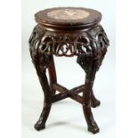 A CHINESE HARDWOOD AND MARBLE INSET STAND, with carved and pierced frieze, supported on four curving