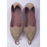 A PAIR OF 19TH CENTURY OTTOMAN METAL THREAD LEATHER EMBROIDERED SHOES, 26cm long.