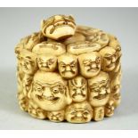 A JAPANESE CARVED IVORY NOH MASK BOX AND COVER, the box carved all over with various theatre masks