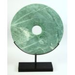 A LARGE CHINESE MARBLE BI DISK, raised on a fitted stand, the stand 40cm diameter, 53cm high on