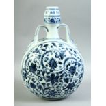 A CHINESE BLUE AND WHITE PORCELAIN TWIN HANDLE MOONFLASK, painted with foliate decoration, 33cm