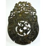 A CHINESE CARVED AND PIERCED HARDSTONE DISK, carved with mythological beasts, 24.5cm x 17.5cm.