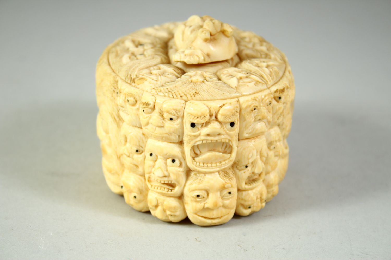 A JAPANESE CARVED IVORY NOH MASK BOX AND COVER, the box carved all over with various theatre masks - Image 2 of 8