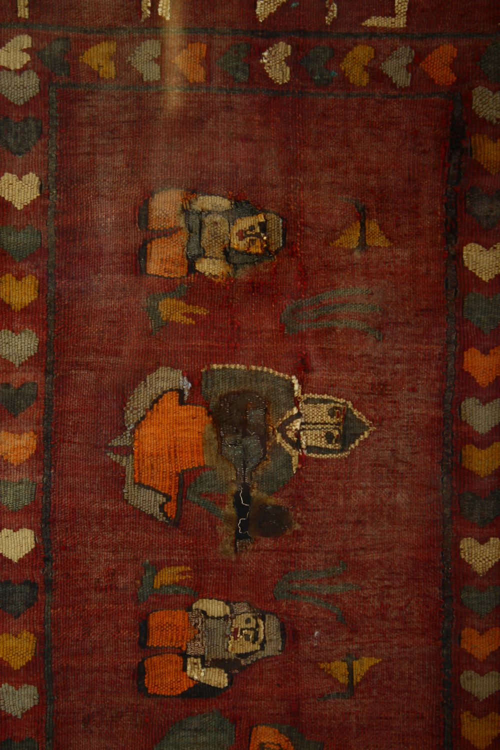 AN ISLAMIC TEXTILE FRAGMENT, the textile embroidered with seated figures and with bands of script, - Image 2 of 4