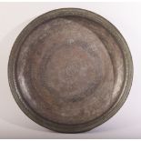 A LARGE 17TH CENTURY PERSIAN SAFAVID BRONZE DISH, with engraved decoration, the centre with a