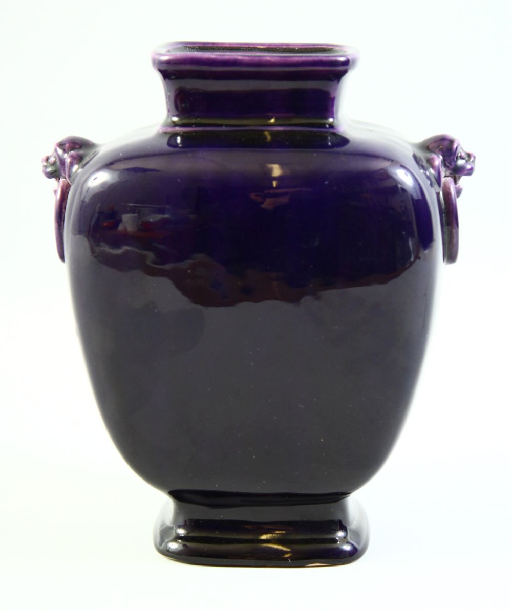 AN EARLY 20TH CENTURY CHINESE AUBERGINE GLAZE PORCELAIN VASE, with twin handles moulded as lion dogs