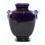 AN EARLY 20TH CENTURY CHINESE AUBERGINE GLAZE PORCELAIN VASE, with twin handles moulded as lion dogs