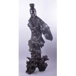 AN EARLY LARGE CHINESE ROOTWOOD CARVED GUANYIN, on a naturalistic base, 101cm high.