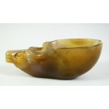 A CHINESE BUFFALO HEAD AGATE CUP, the predominantly celadon green stone with russet and white