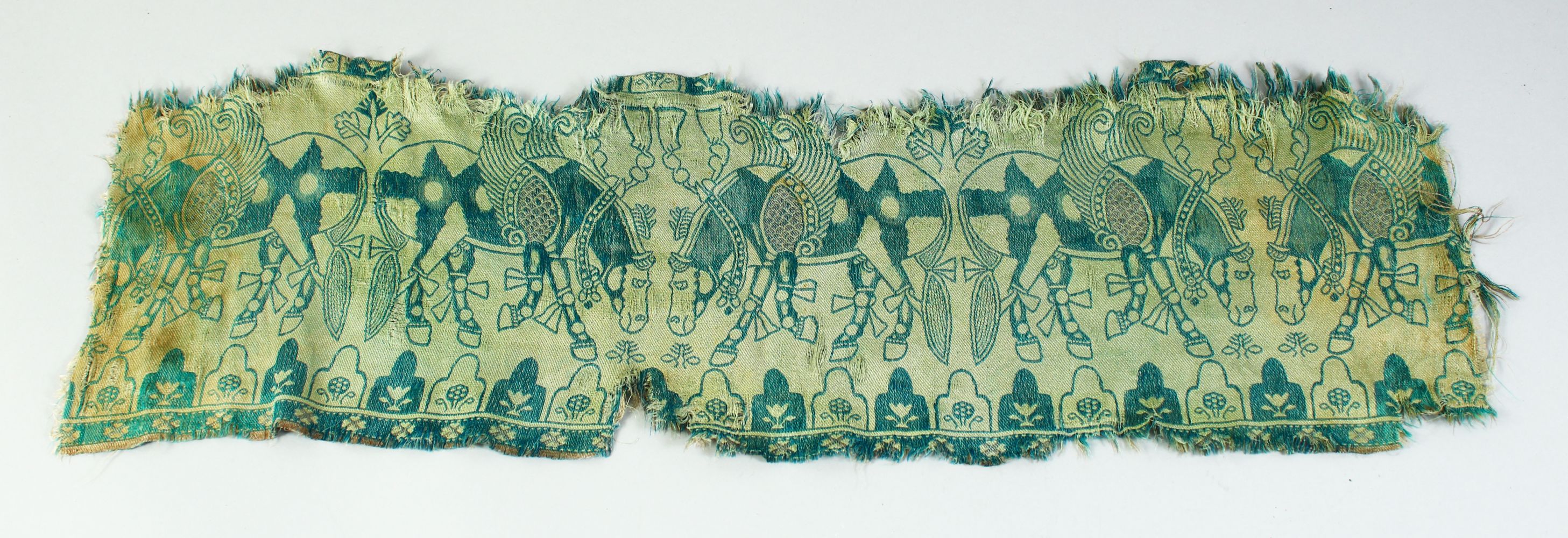 AN ISLAMIC TEXTILE FRAGMENT, embroidered with horses.