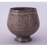 A FINE ISLAMIC SILVER INLAID BRASS GOBLET, decorated with a band of calligraphy, 8.5cm high.