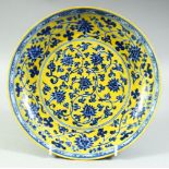 A CHINESE YELLOW GROUND BLUE AND WHITE PORCELAIN DISH, decorated with lotus and vine, six