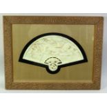 A CHINESE CARVED HARDSTONE FAN SHAPE PLAQUE, carved with birds on a tree branch, framed and