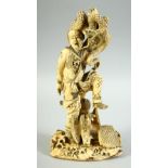 A JAPANESE CARVED IVORY OKIMONO, of a male figure holding a snake aloft, the man with an eagle at