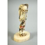 AN UNUSUAL JAPANESE CARVED IVORY OKIMONO, depicting a skeleton and two monkeys, 11.5cm high.