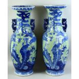 A LARGE PAIR OF CHINESE CELADON BLUE AND WHITE PORCELAIN VASES, with raised decoration depicting