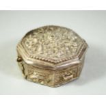 AN ISLAMIC WHITE METAL OCTAGONAL QURAN AMULET BOX, possibly silver, 5.5cm diameter.