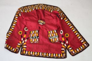A TURKAMAN COAT, with colourfully printed lining, the sleeves and edging embroidered with stylised