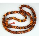 A HORN NECKLACE, weighing 89.1gm, composed of flattened circular beads, approx. 31in long.