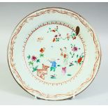 A CHINESE FAMILLE ROSE PORCELAIN PLATE, painted with a female figure and child, 22.5cm diameter.