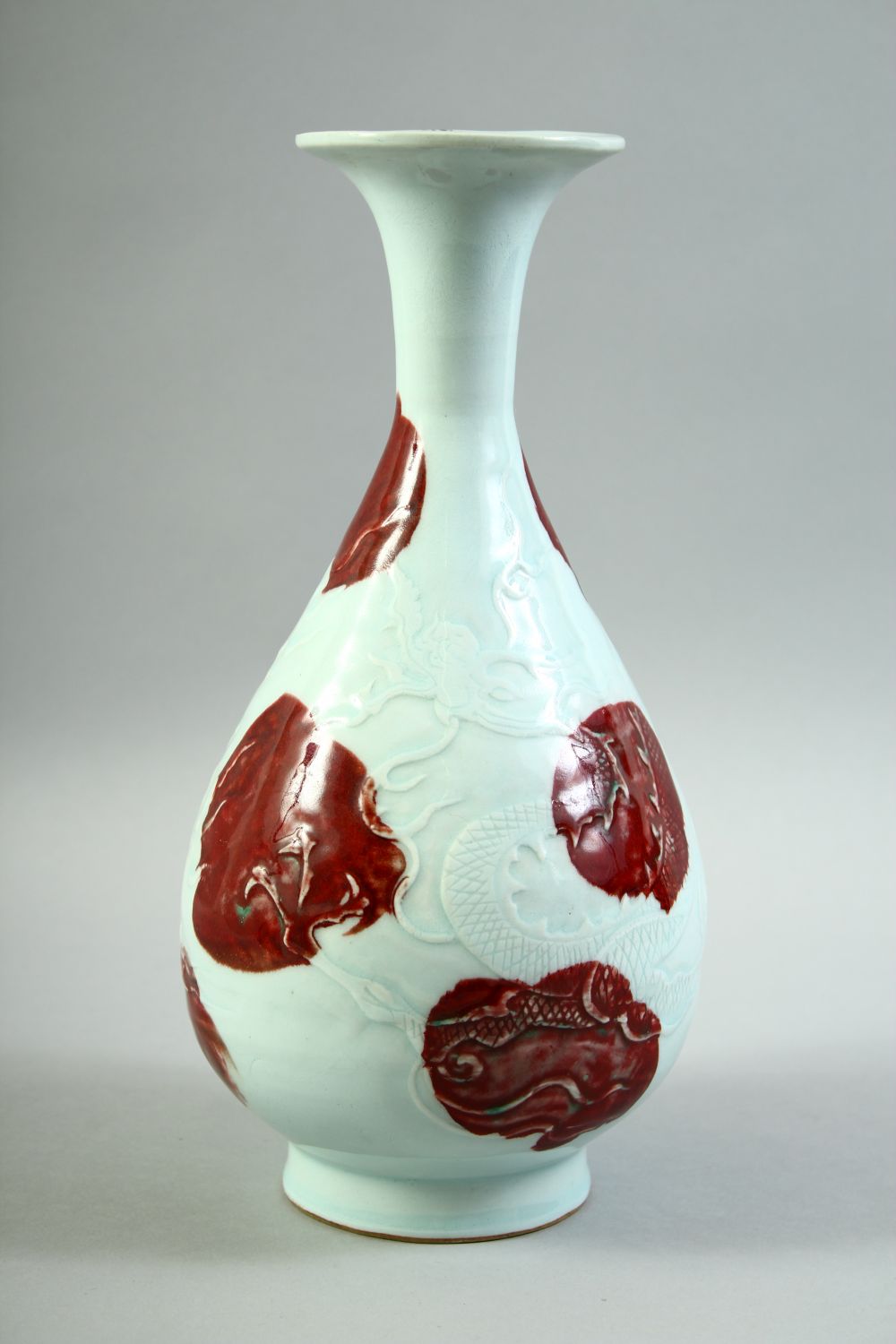 A CHINESE UNDER GLAZED RED AND WHITE DRAGON VASE, the body carved with a dragon and stylised flames, - Image 4 of 6