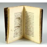 AN ISLAMIC LEATHER BOUND SCHOLAR'S ASTROLOGY BOOK, the book containing writings and various