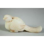 A CARVED SOAPSTONE MODEL OF A BIRD, 11cm long.