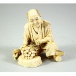A JAPANESE CARVED IVORY OKIMONO, of a wood cutter, the base inset with red seal tablet, 7cm high.