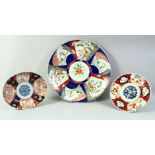 A LARGE JAPANESE IMARI PORCELAIN CHARGER, 40cm diameter, together with an imari dish and an imari