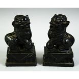 A PAIR OF 19TH CENTURY CHINESE CRAVED BLACK HARDSTONE FO DOGS, 10cm high.