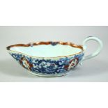 A CHINESE BLUE AND WHITE / FAMILLE ROSE PORCELAIN SAUCE BOAT, the interior painted with a garden