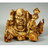 A JAPANESE CARVED IVORY OKIMONO, depicting a bearded figure surrounded by rats, 8cm wide.